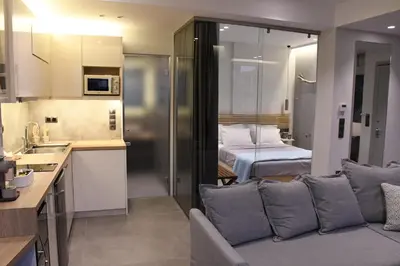 a kitchen and a living room with a couch and a bed at ATHENS PHOS Brand New Loft in Historical Athens Historical Center in Athens