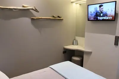 a room with a bed and a tv on the wall at ATHENS PHOS Brand New Loft in Historical Athens Historical Center in Athens