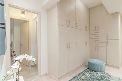 a room with white cabinets and a blue stool at Kleio by Heloni Apartments in Athens