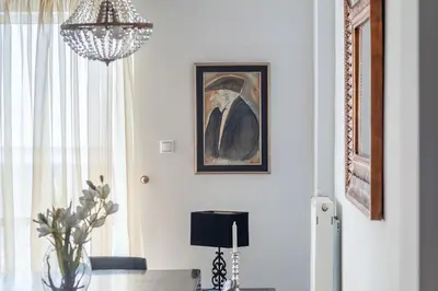 a dining room with a table and a chandelier at Kleio by Heloni Apartments in Athens