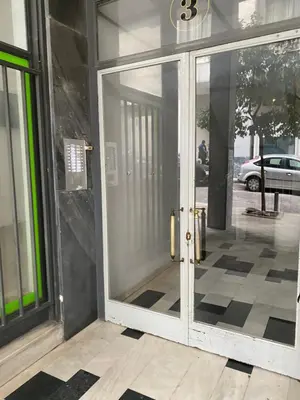 an entrance to a building with a glass door at Syntagma private sweet safe double rooms with shared bathroom in Athens