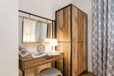 a dressing room with a mirror and a wooden wall at Syntagma private sweet safe double rooms with shared bathroom in Athens