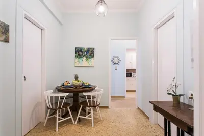 a kitchen and dining room with a table and chairs at Syntagma private sweet safe double rooms with shared bathroom in Athens