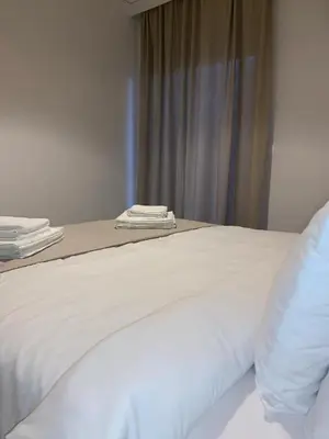 a close up of a white bed in a room at Treasure cosy flat in Athens