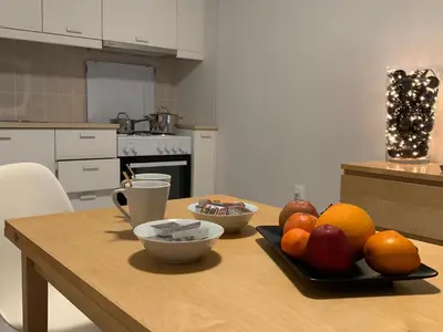 a table with a plate of fruit on it in a kitchen at Treasure cosy flat in Athens