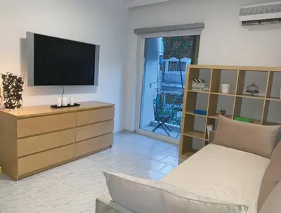 a living room with a tv and a couch at Treasure cosy flat in Athens