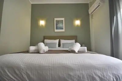 a bedroom with a large bed with white sheets and pillows at Check Point - Plaka in Athens