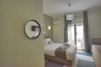 a hotel room with a bed and a mirror at Check Point - Plaka in Athens