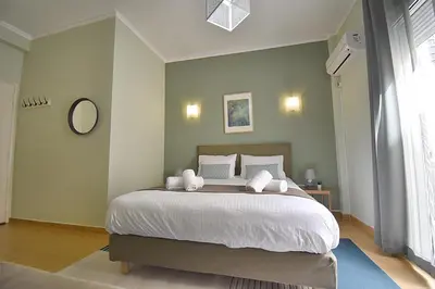 a bedroom with a large bed with white sheets at Check Point - Plaka in Athens