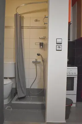 a shower in a bathroom with a toilet at Check Point - Down Town in Athens