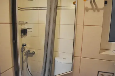 a small bathroom with a shower with a toilet at Check Point - Down Town in Athens