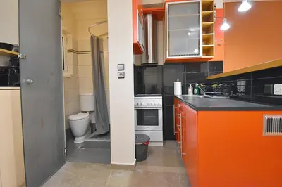 a small kitchen with a sink and a toilet at Check Point - Down Town in Athens