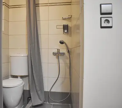 a bathroom with a shower with a toilet at Check Point - Down Town in Athens