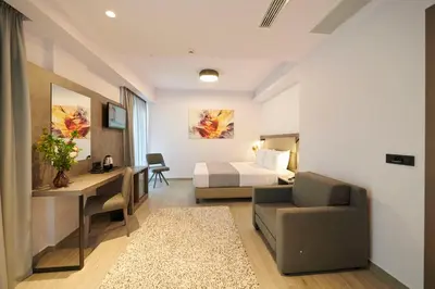 a hotel room with a bed and a desk at Meni Hotel & Apartments UNDER NEW MANAGEMENT in Athens