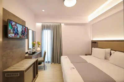 a hotel room with a bed and a desk at Meni Hotel & Apartments UNDER NEW MANAGEMENT in Athens