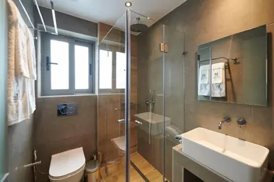 a bathroom with a toilet and a sink and a shower at Meni Hotel & Apartments UNDER NEW MANAGEMENT in Athens