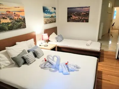 a hotel room with two beds with towels on them at Comfortable apartment in Acropolis in Athens