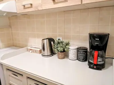 a kitchen counter with a coffeemaker and a coffee maker at Comfortable apartment in Acropolis in Athens
