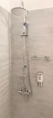 a shower with a shower head in a bathroom at Comfortable apartment in Acropolis in Athens