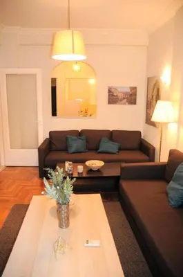 a living room with a couch and a table at Comfortable apartment in Acropolis in Athens