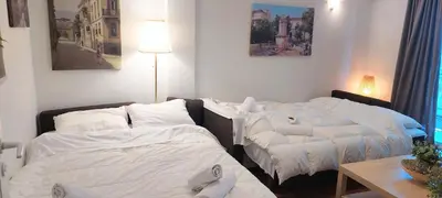 two beds sitting next to each other in a room at Comfortable apartment in Acropolis in Athens
