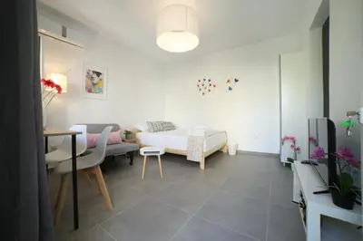 a living room with a bed and a table at Cozy Studio 4U Gazi - Center Athens in Athens