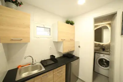 a small kitchen with a sink and a washing machine at Cozy Studio 4U Gazi - Center Athens in Athens