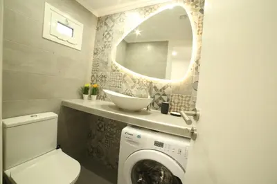 a bathroom with a washing machine and a mirror at Cozy Studio 4U Gazi - Center Athens in Athens