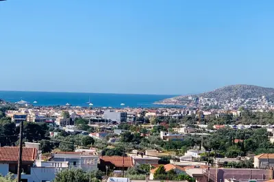 a view of a city with the ocean in the background at Thelfi Luxury studio in Attica - close to varkiza beach - Sea view in Vari
