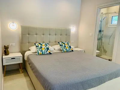 a bedroom with a large bed with two pillows at Thelfi Luxury studio in Attica - close to varkiza beach - Sea view in Vari