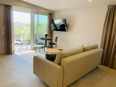 a living room with a couch and a tv at Thelfi Luxury studio in Attica - close to varkiza beach - Sea view in Vari