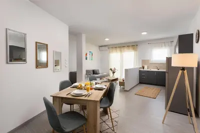a dining room and living room with a table and chairs at The Aristotelian Suites by Athens Stay in Athens