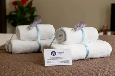 three stacks of towels on a table with a sign at The Aristotelian Suites by Athens Stay in Athens