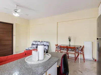 a living room with a red couch and a table at Apartment in Piraeus near Athens Riviera in Athens