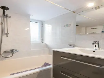 a bathroom with a tub and a sink and a bath tubermottermott at Apartment in Piraeus near Athens Riviera in Athens