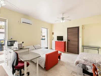 a bedroom with a bed and a desk with a microwave at Apartment in Piraeus near Athens Riviera in Athens