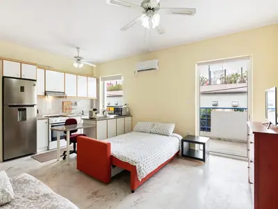 a living room with a bed and a kitchen at Apartment in Piraeus near Athens Riviera in Athens