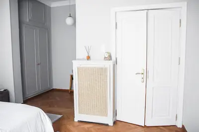 a bedroom with a bed and a white door at API Projects Athens - Parliament Apartment in Athens