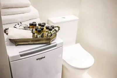 a bathroom with a toilet and a basket of wine bottles at API Projects Athens - Parliament Apartment in Athens
