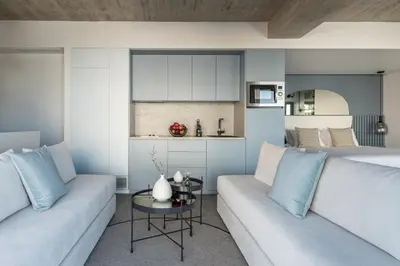 a living room with a couch and a kitchen at Urban Suites in Athens