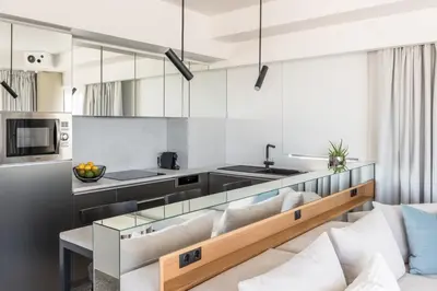 a living room with a couch and a kitchen at Urban Suites in Athens
