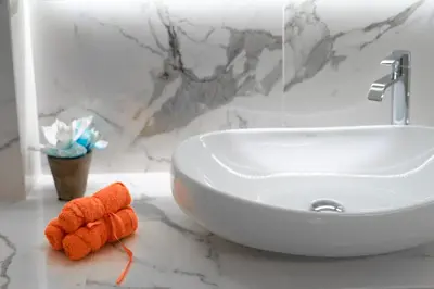 a bathroom counter with a sink and a orange object at Amazing apartment in Glyfada center in Athens