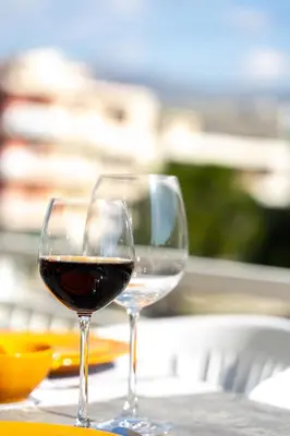 two glasses of wine sitting on a table at Amazing apartment in Glyfada center in Athens