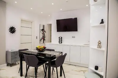 a dining room with a black table and chairs at Amazing apartment in Glyfada center in Athens