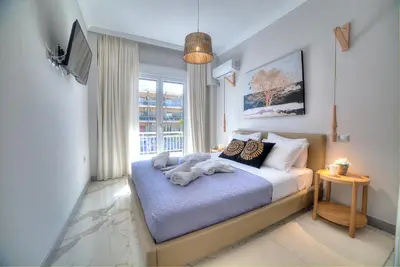 a bedroom with a bed with a dog laying on it at Amazing apartment in Glyfada center in Athens