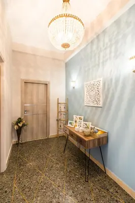 a room with a table and a chandelier at Hidden Paradise in Piraeus