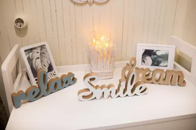 a white table with two pictures and a candle at Hidden Paradise in Piraeus
