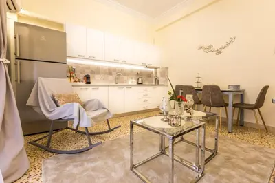 a kitchen with a table and chairs and a refrigerator at Hidden Paradise in Piraeus