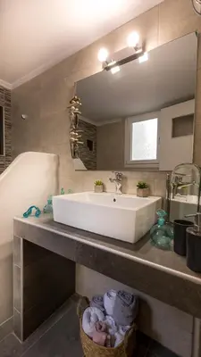 a bathroom with a white sink and a tub at Hidden Paradise in Piraeus