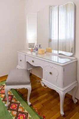 a white desk with a mirror and a stool at Acropolis Now! 2BR in central Athens in Athens